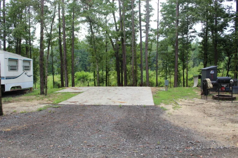 Full hookup RV lot with poured concrete pad and fire pit at Backwoods RV Park, Phenix City AL